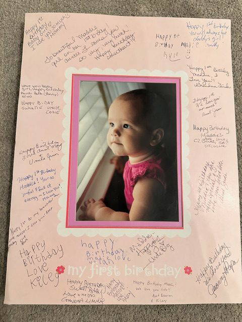 First-birthday photo mat signed by family and friends