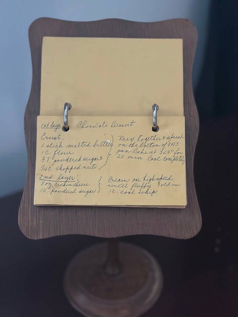 Handwritten recipe flipbook on a wooden stand